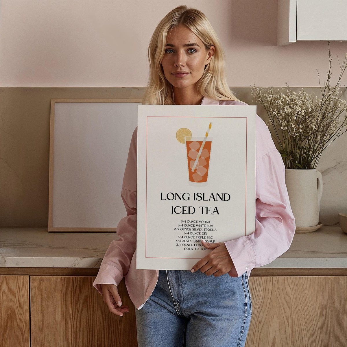 Person holding a Bar Sign Decor print of a Long Island Iced Tea cocktail recipe with orange and black text