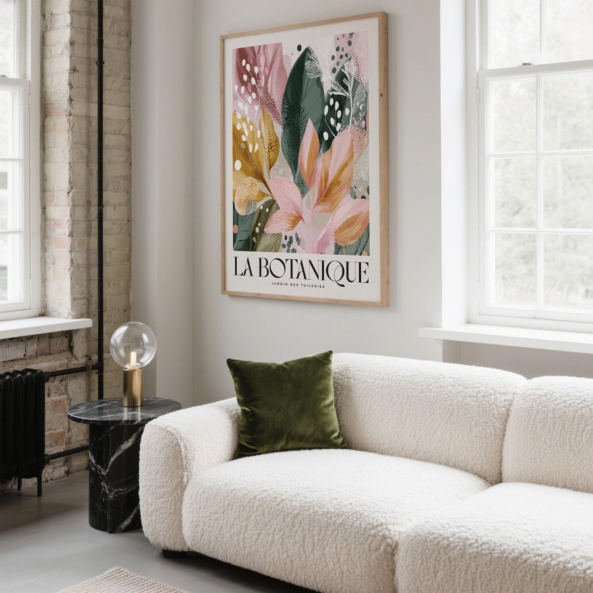 Modern Flower Wall Art print with abstract botanical leaves in pink and green above a white textured sofa