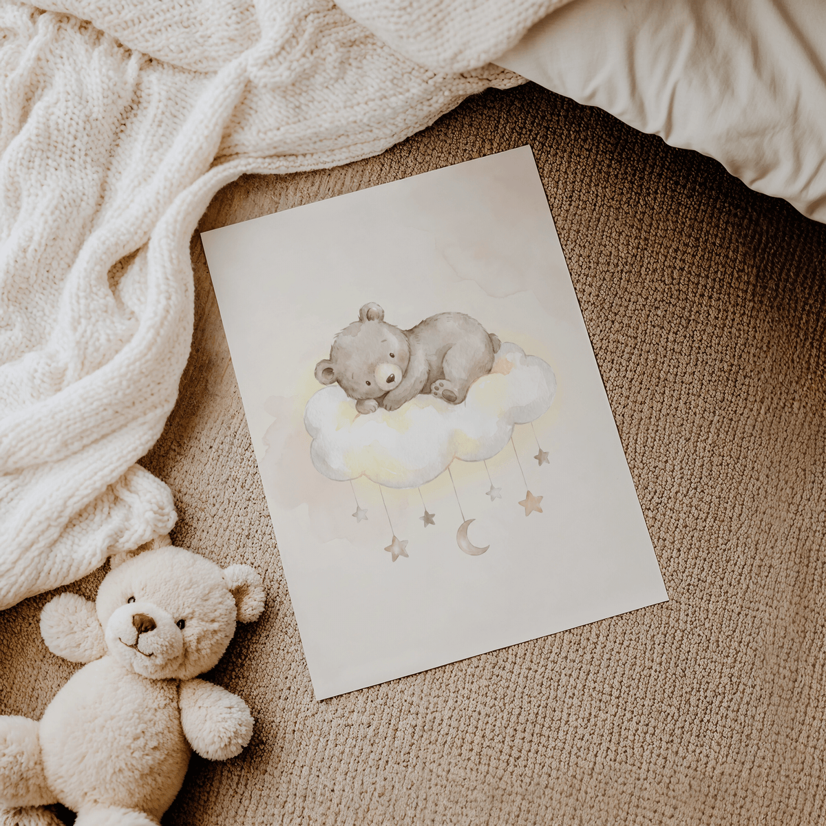 Bear Cloud Art Print laid on carpet beside knitted blanket and teddy bear toy