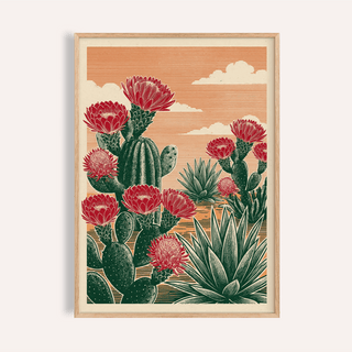Framed Cactus Desert Art showing green cacti with red flowers and an orange sky background