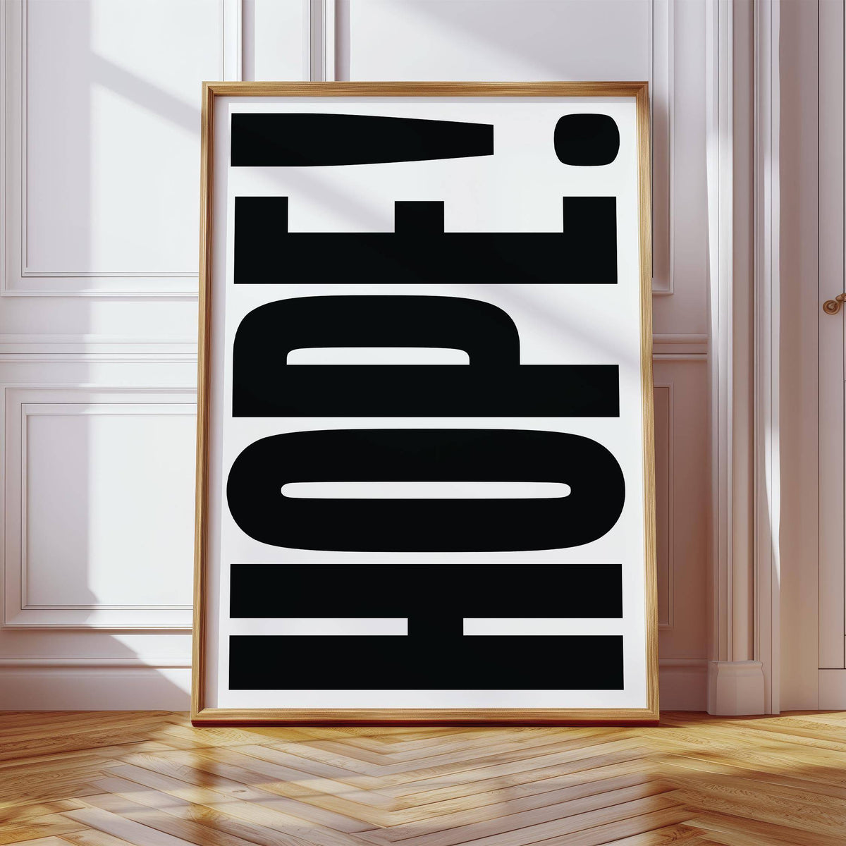 Motivational Work Posters print of large black HOPE text in a wooden frame leaning on floor by white moulded wall