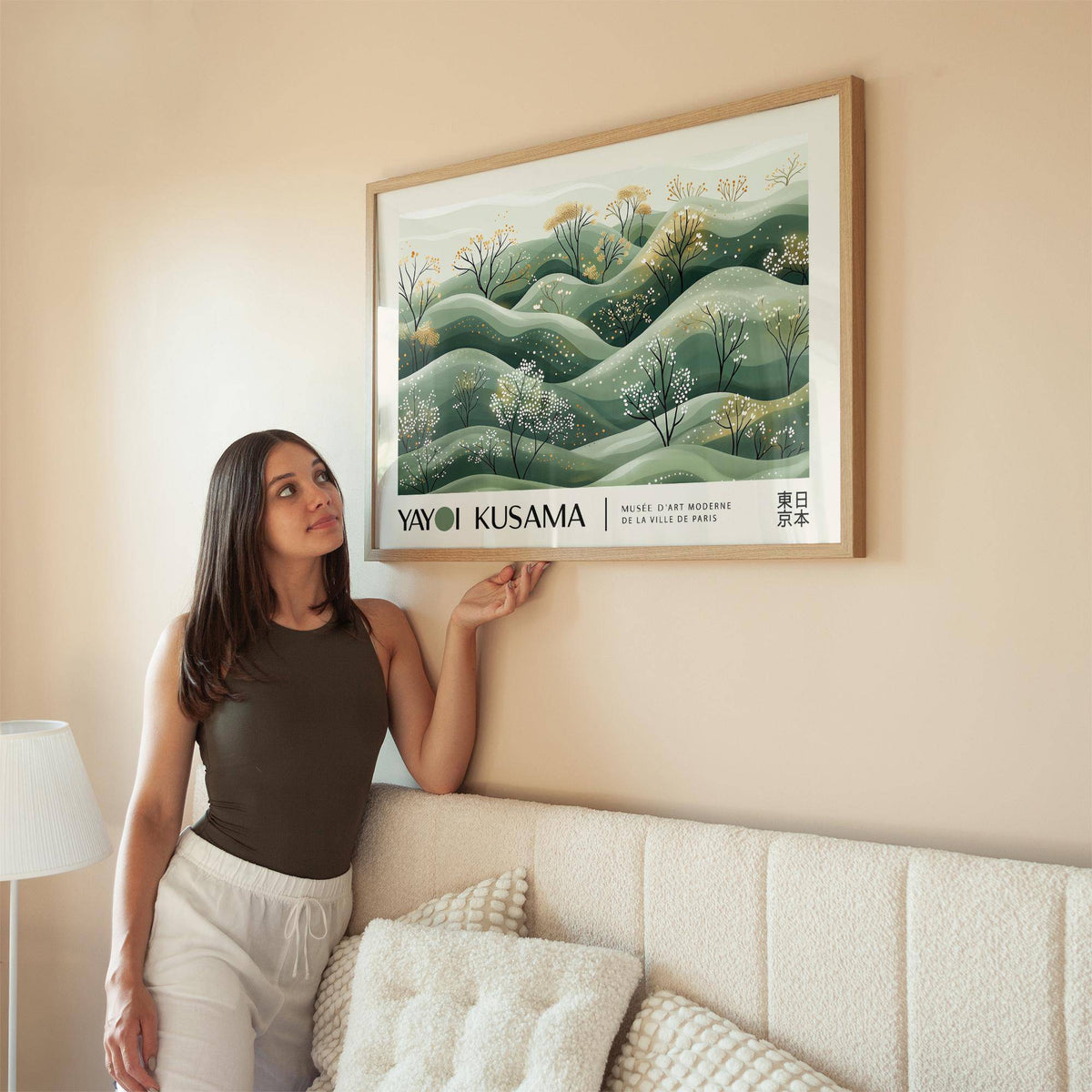 Landscape art prints framed print of hills with blossoming trees in soft green hues above a sofa