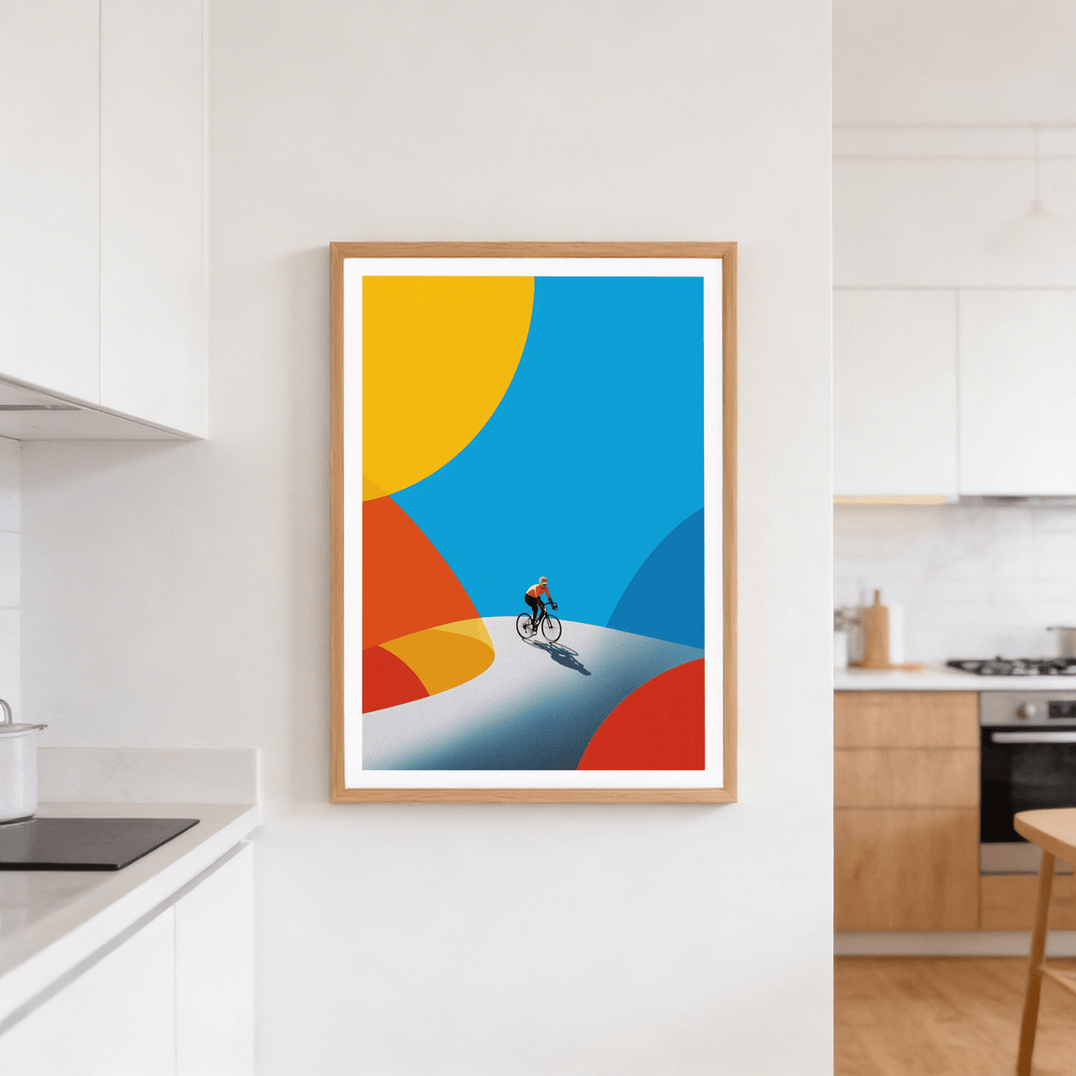 Cycling art print of a cyclist on a winding road with bold blue, yellow and red shapes in a kitchen