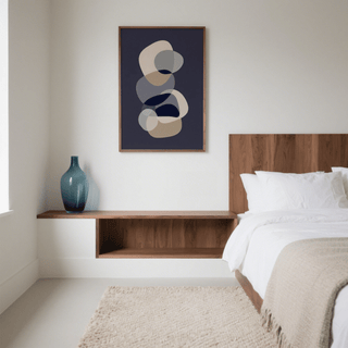 Abstract Modern Art framed print of overlapping beige and grey shapes in a minimalist bedroom with a blue glass vase