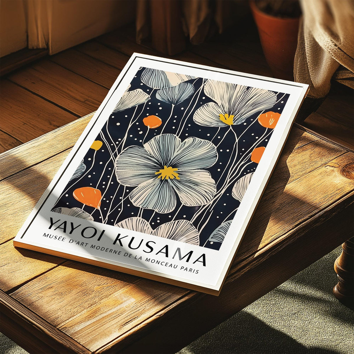Large Flower Wall Art print with cream and orange blooms lying on a wooden table
