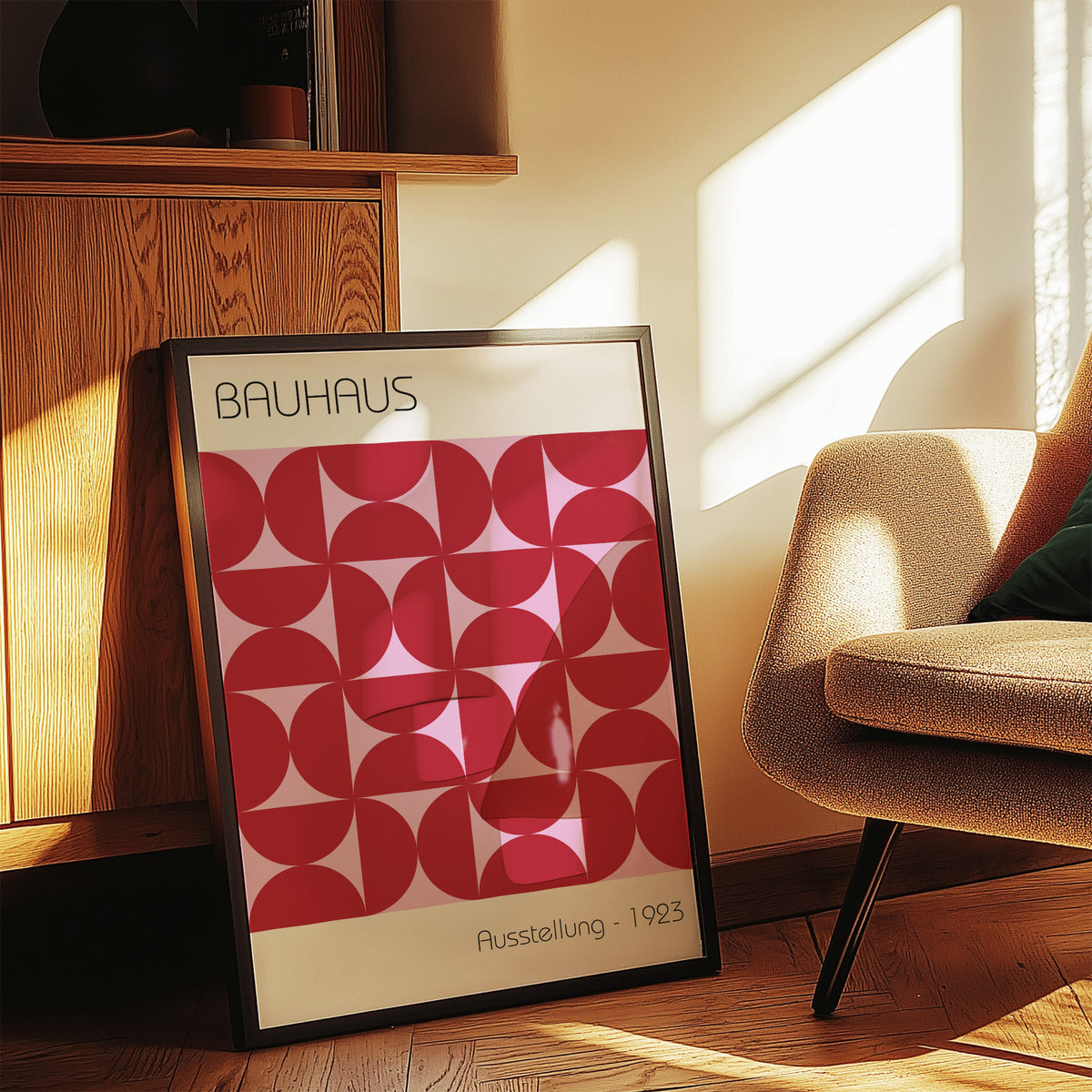 Print leaning on a floor with Bauhaus Artworks red geometric pattern and minimalist style near a beige armchair