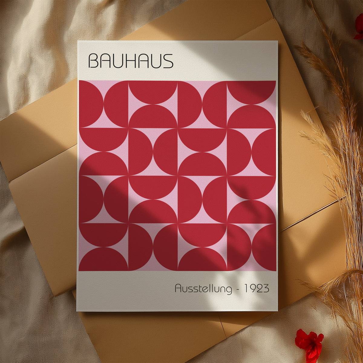 Bauhaus artworks with red geometric shapes and typography on paper with dried plants nearby