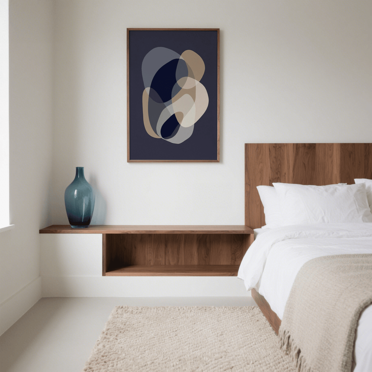 Prints Abstract Art framed print of abstract organic shapes in blue grey beige above a wooden shelf with a blue glass vase in bedroom