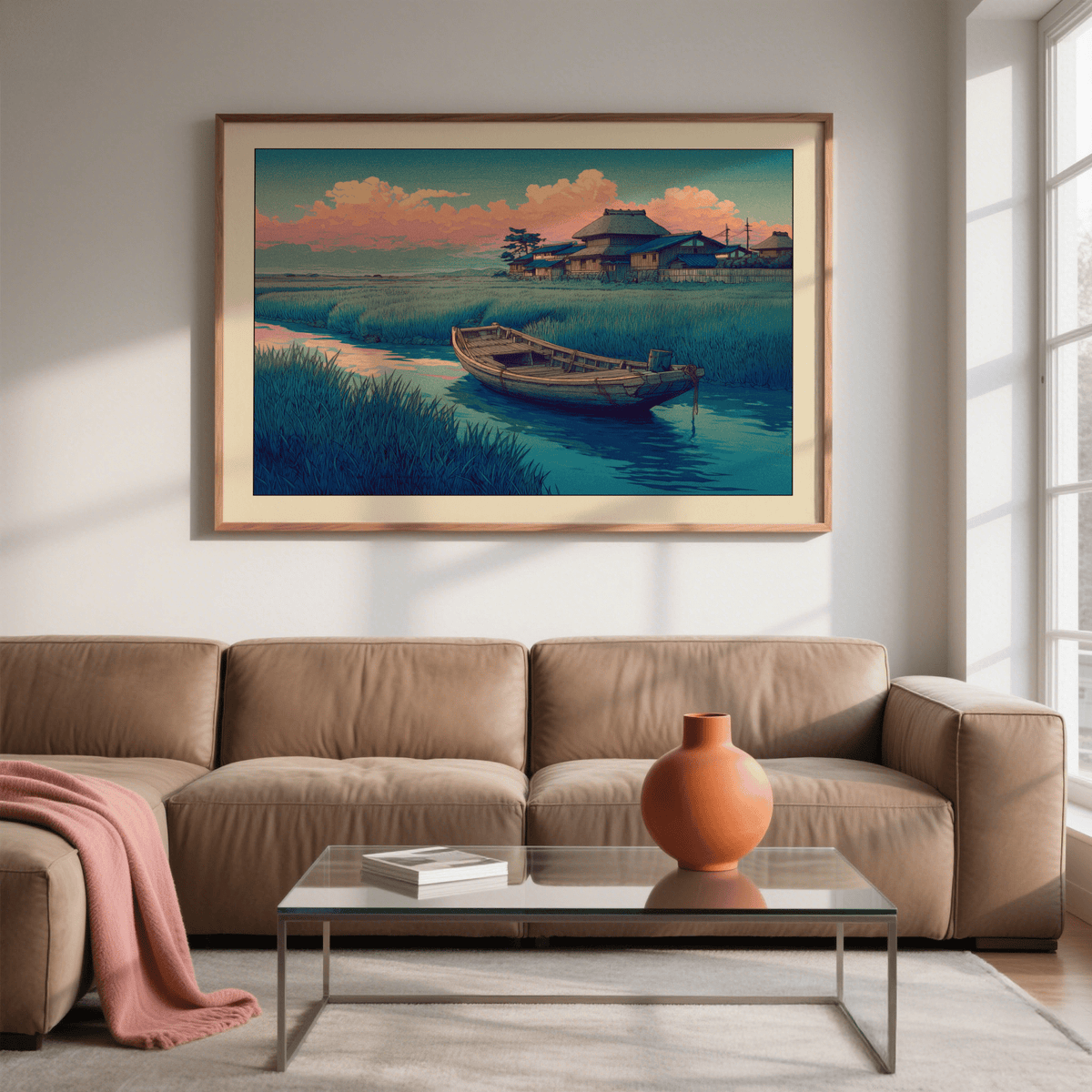 Hasui Kawase River Boat print on a wall with wooden frame above tan sofa and glass coffee table with orange vase