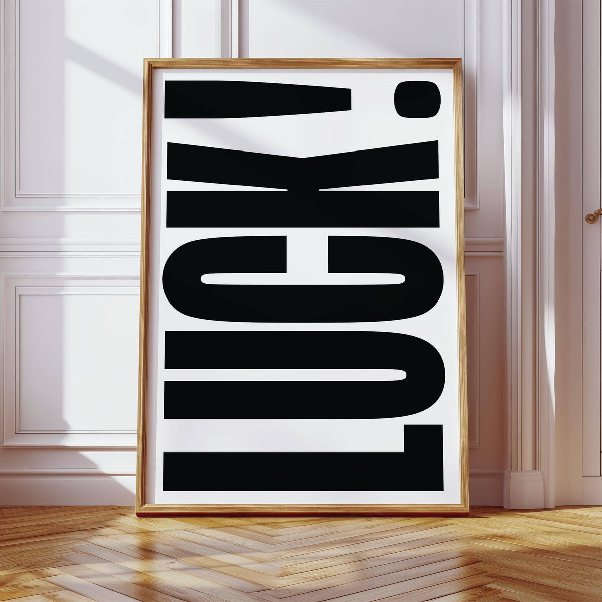 Good Luck Print leaning on wooden floor vertical with black bold typography and white background