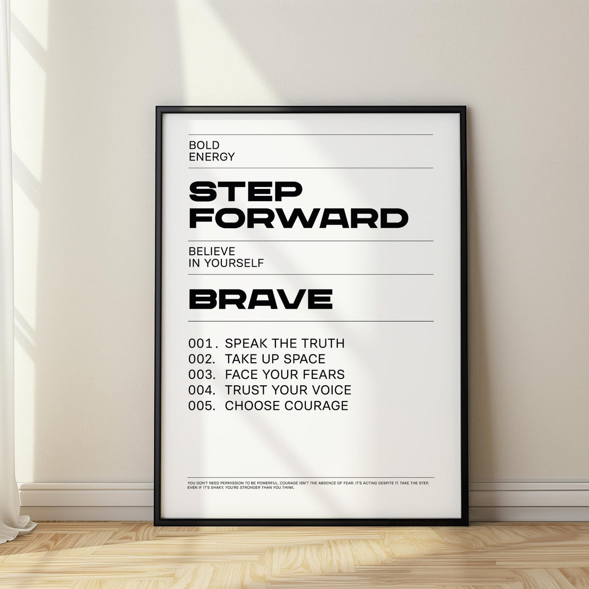 Framed Inspirational Quotes Artwork with black typographic text step forward leaning against a wall with natural light