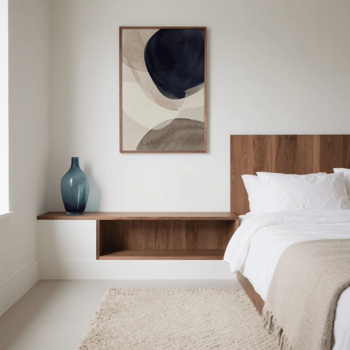 Abstract Watercolor Print hanging above bed in bedroom with blue vase on wood shelf