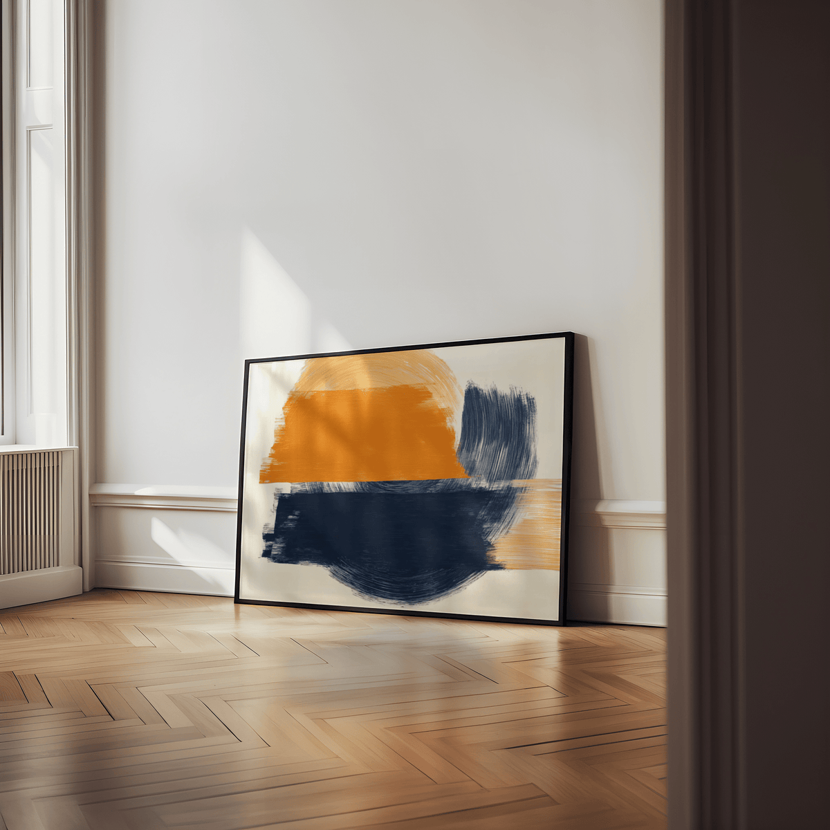 Print leaning on floor of blue and orange abstract art with minimalist brushstrokes in a light room