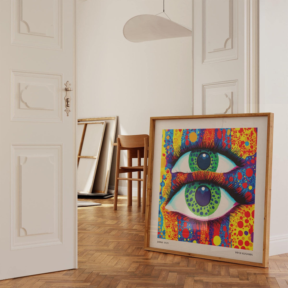 Print leaning on a floor with wooden parquet of a green eyed surreal abstract pop art in warm colours