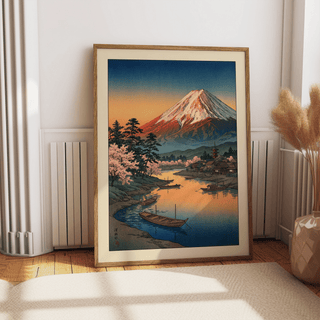 Framed Mount Fuji Sunset Poster with boats and cherry blossom leaning on the floor near a radiator