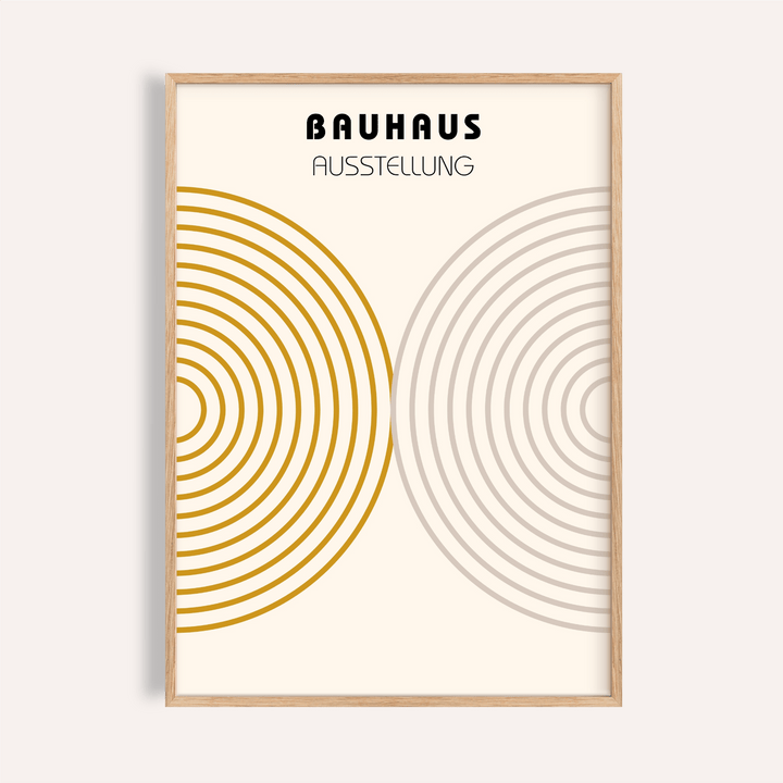 Minimalist wall decor with concentric circles in gold and grey in a light wooden frame