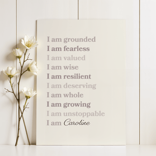 Custom Quote Poster leaning with a white flower sprig beside it with beige and grey text on cream background