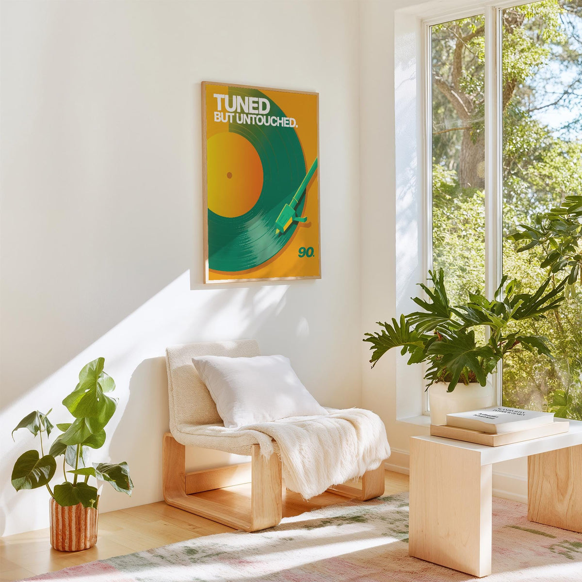 Vinyl Record Art Print hung on a white wall above a wooden chair with a white cushion and blanket in a bright room with plants