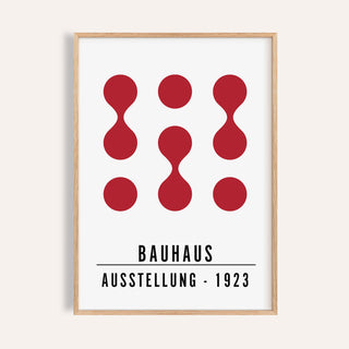 Close-up of artwork for office walls with red abstract shapes and black text in a wooden frame