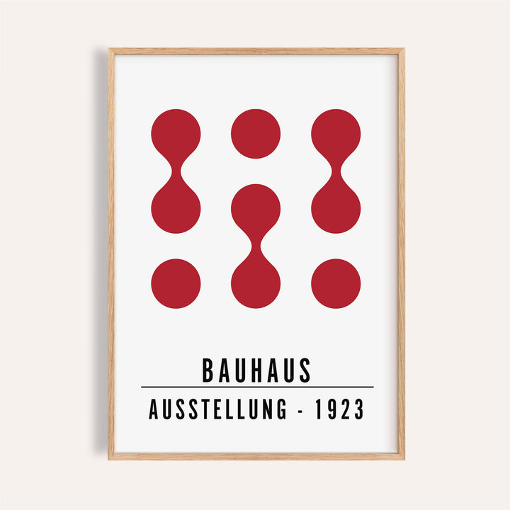 Close-up of artwork for office walls with red abstract shapes and black text in a wooden frame
