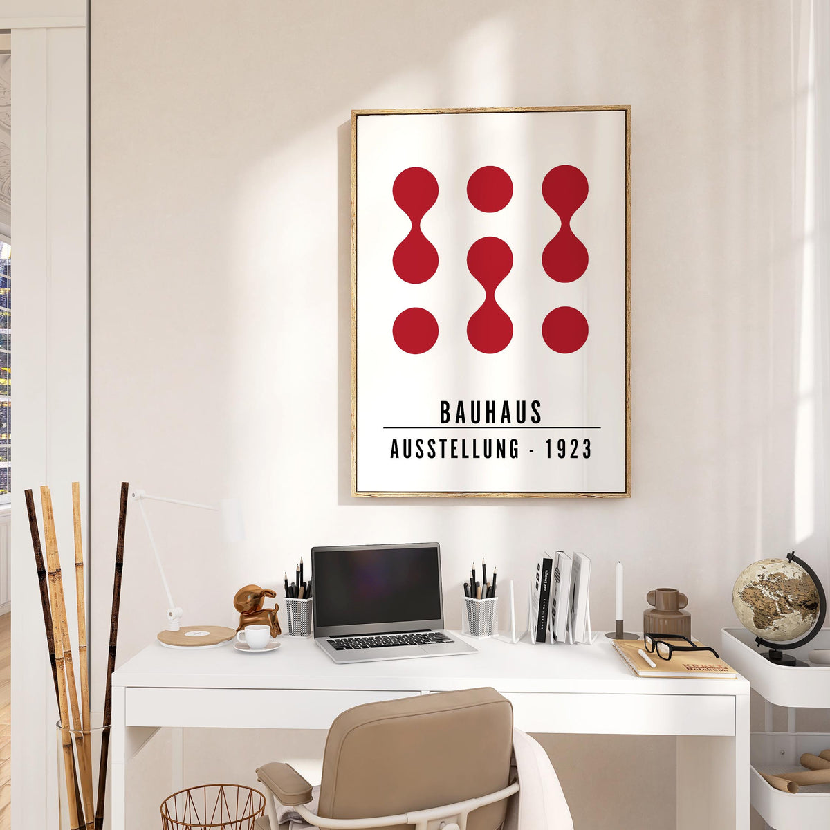 Artwork for Office Walls in an office with abstract red shapes and Bauhaus text above a white desk and lamp