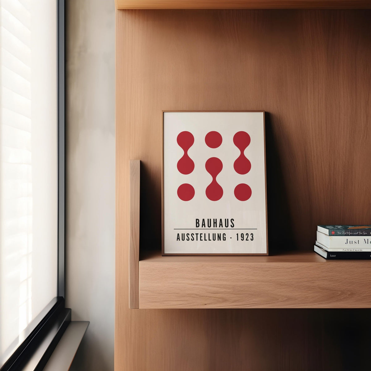 Artwork for Office Walls print with abstract red shapes on a wooden shelf by a window with blinds