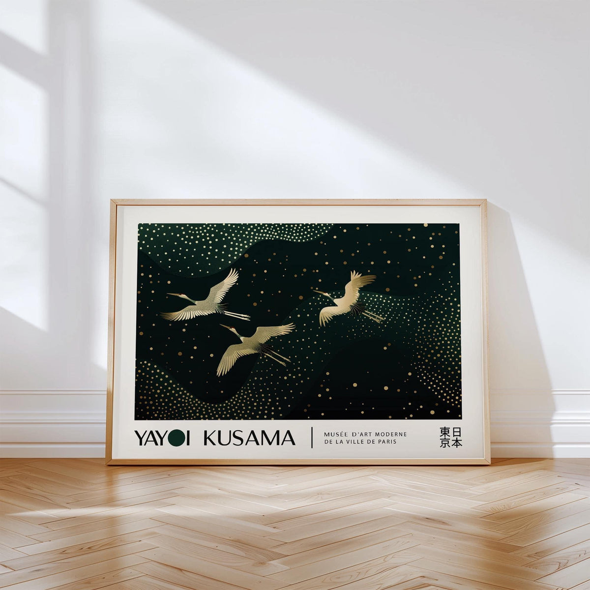 Print leaning on a floor of golden cranes on a dark green background with scattered gold dots