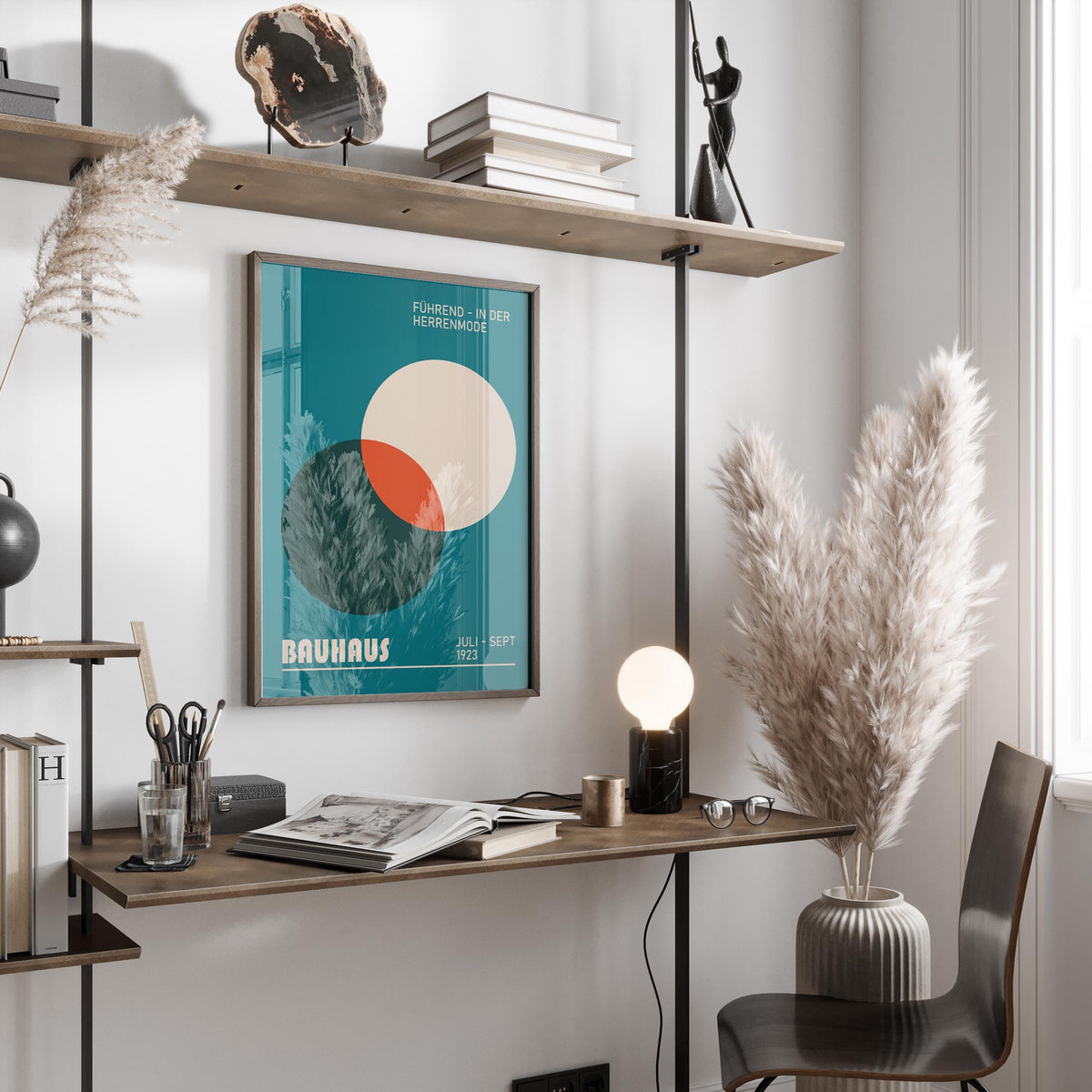 Modern office wall art with overlapping circles and typographic elements on a white wall above a wooden desk with pampas grass