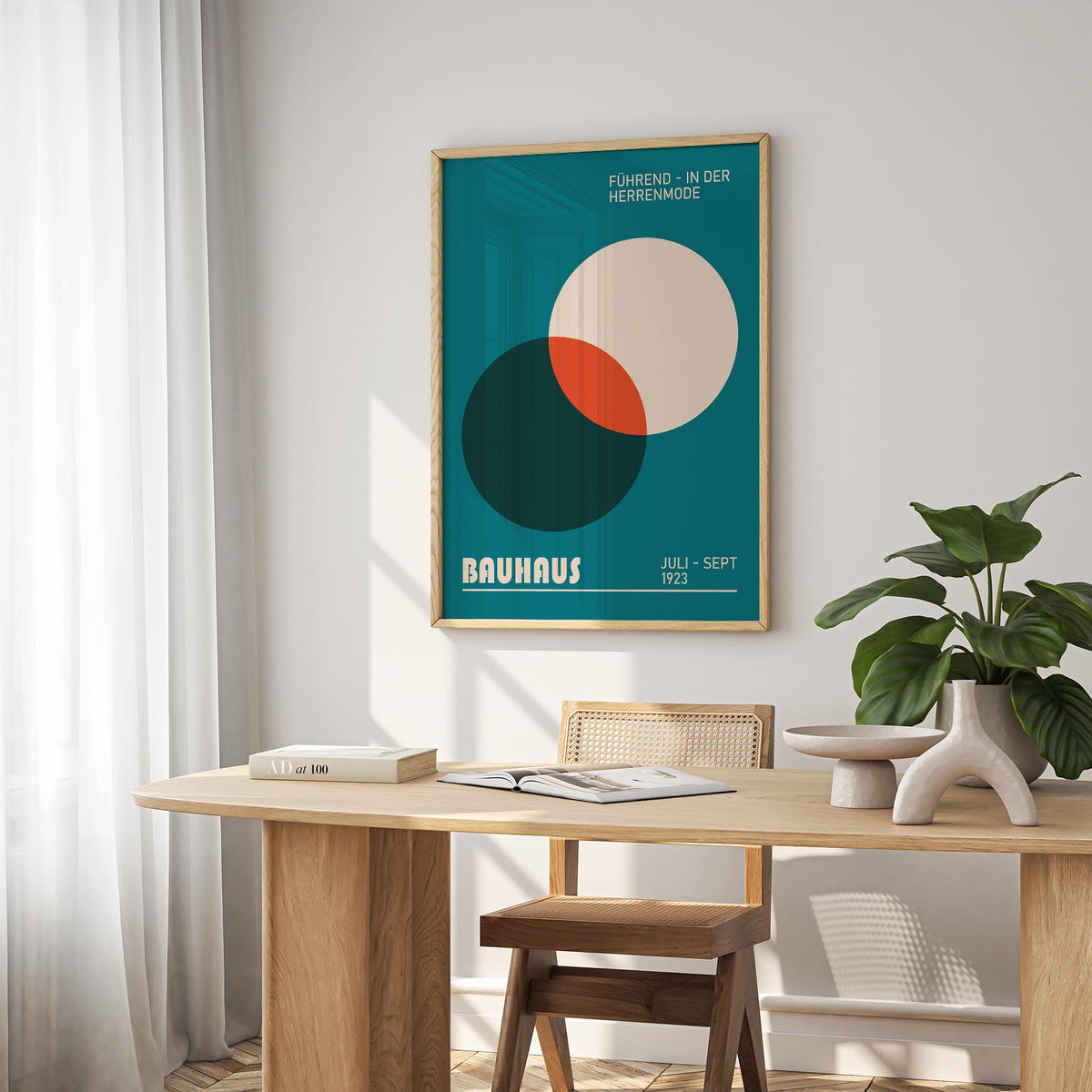 Modern Office Wall Art of overlapping circles in teal, cream and orange above a wooden desk with a book and plant