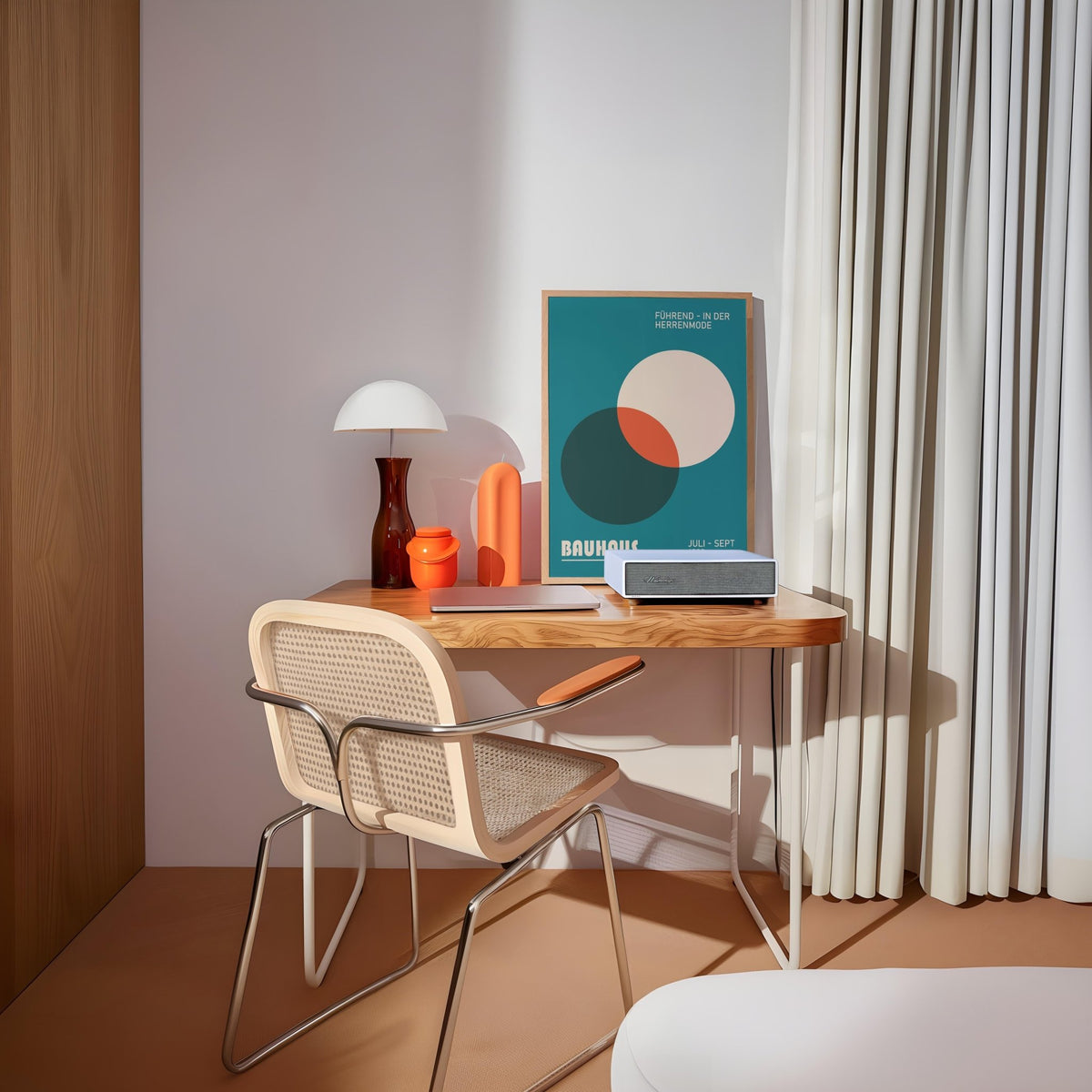 Modern Office Wall Art with overlapping circles in teal, cream and orange above a wooden desk with lamp