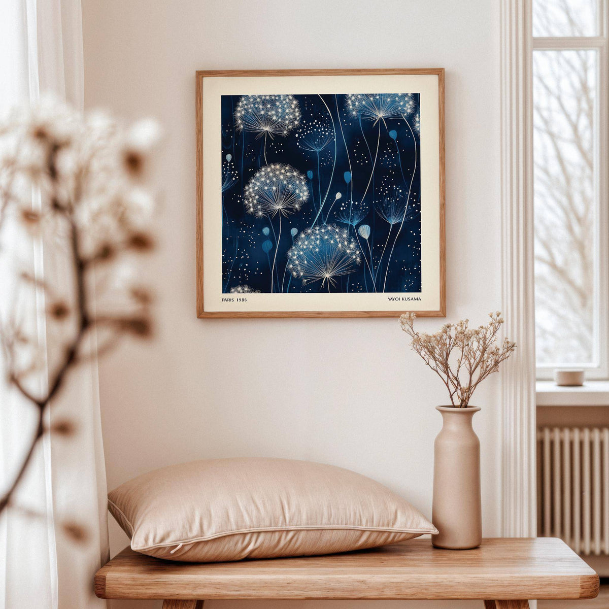 Blue Art Work of delicate dandelion seed heads in white and blue tones above a wooden bench with a cushion