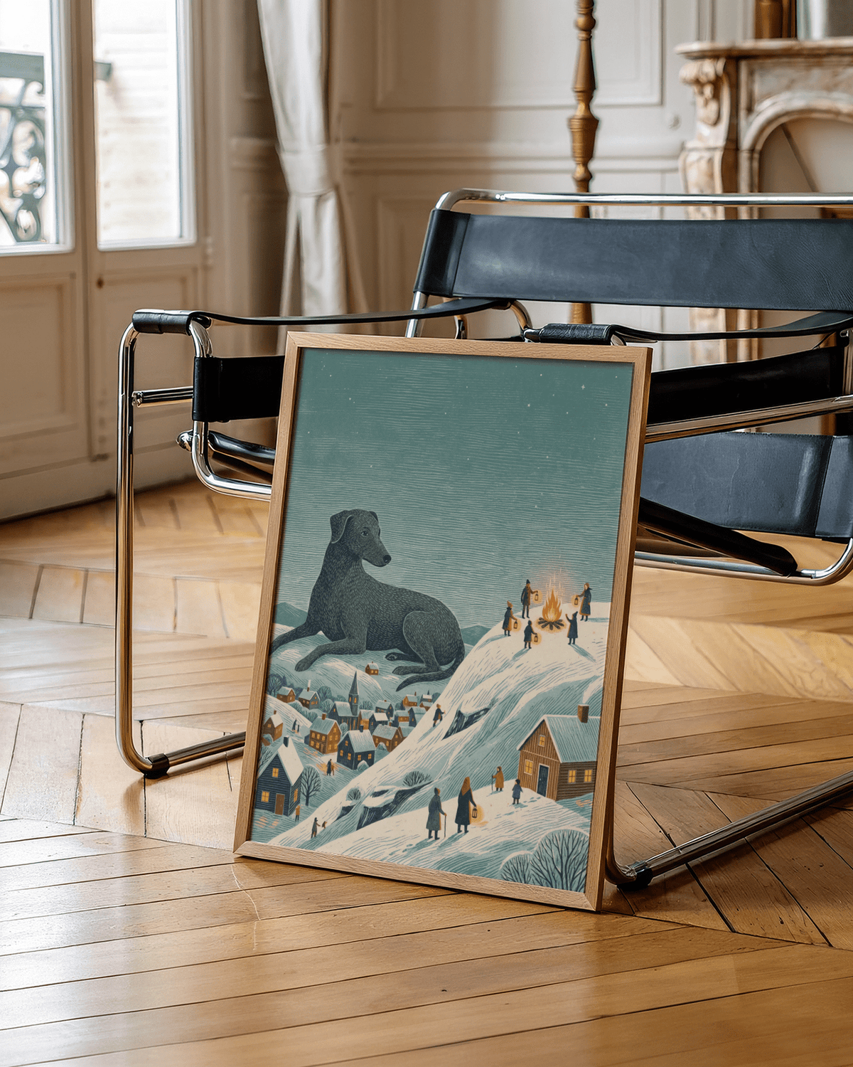 Winter Landscape wall art print leaning on floor beside a black chair in a wooden floor room