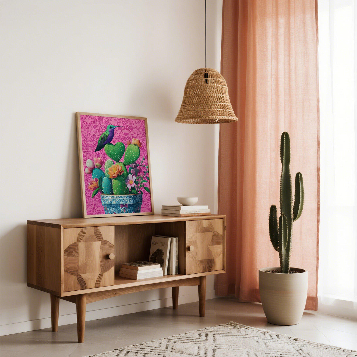 Print leaning on a shelf of a heart shaped cactus with hummingbird and flowers against a pink background