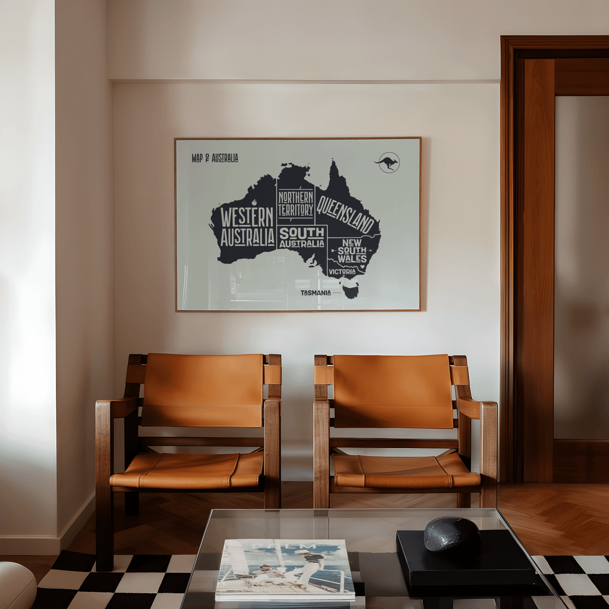 Australia Map Print on a beige wall above two brown leather chairs in a living room