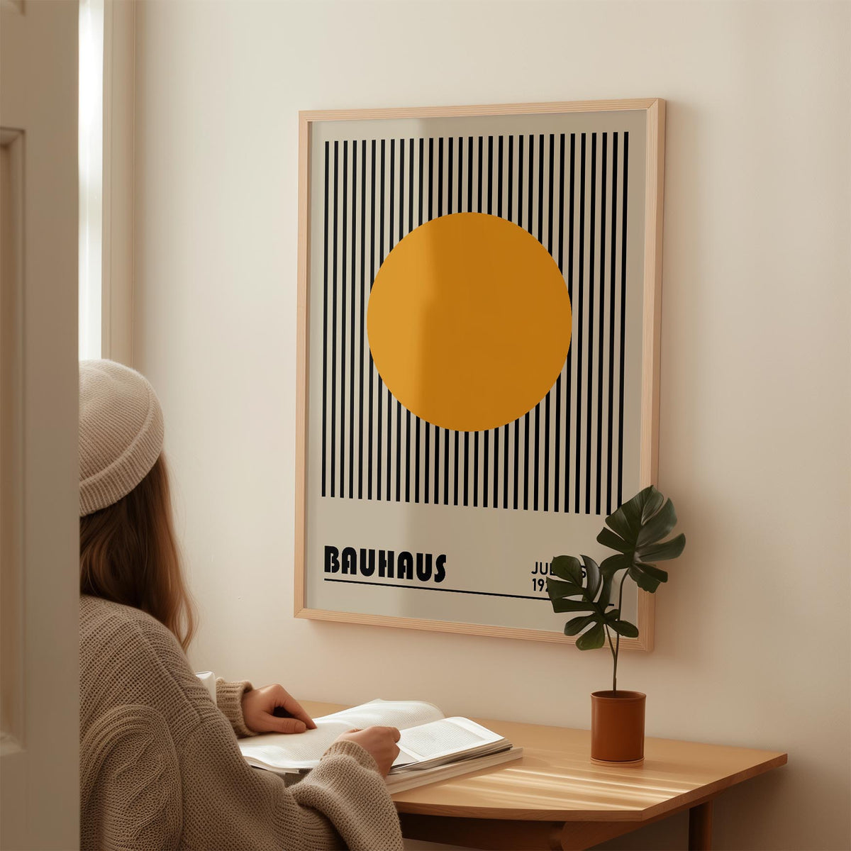 Professional Office Wall Art with orange circle on black and grey stripes above a wooden desk with a plant