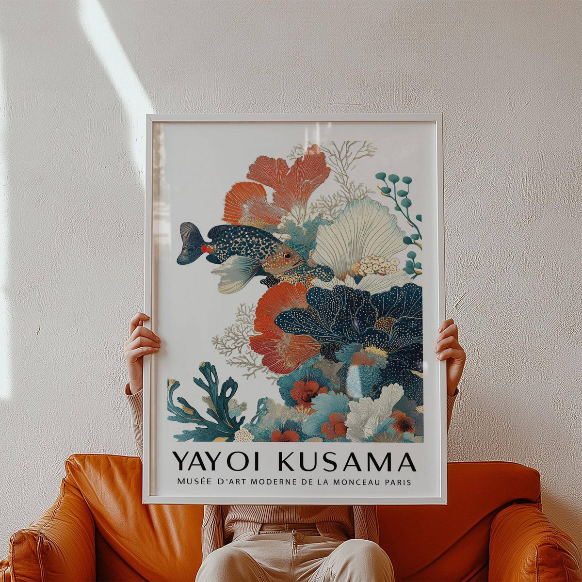 Tropical Fish Poster held in hands showing coral and fish illustration in muted colours