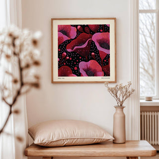 Abstract Pink Art wall art of pink poppy flowers on a dark background above a wooden table with a beige pillow and vase