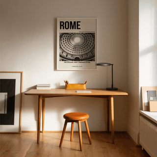Pantheon Interior Poster on a wall above a wooden desk with a lamp and orange tray in a bright room
