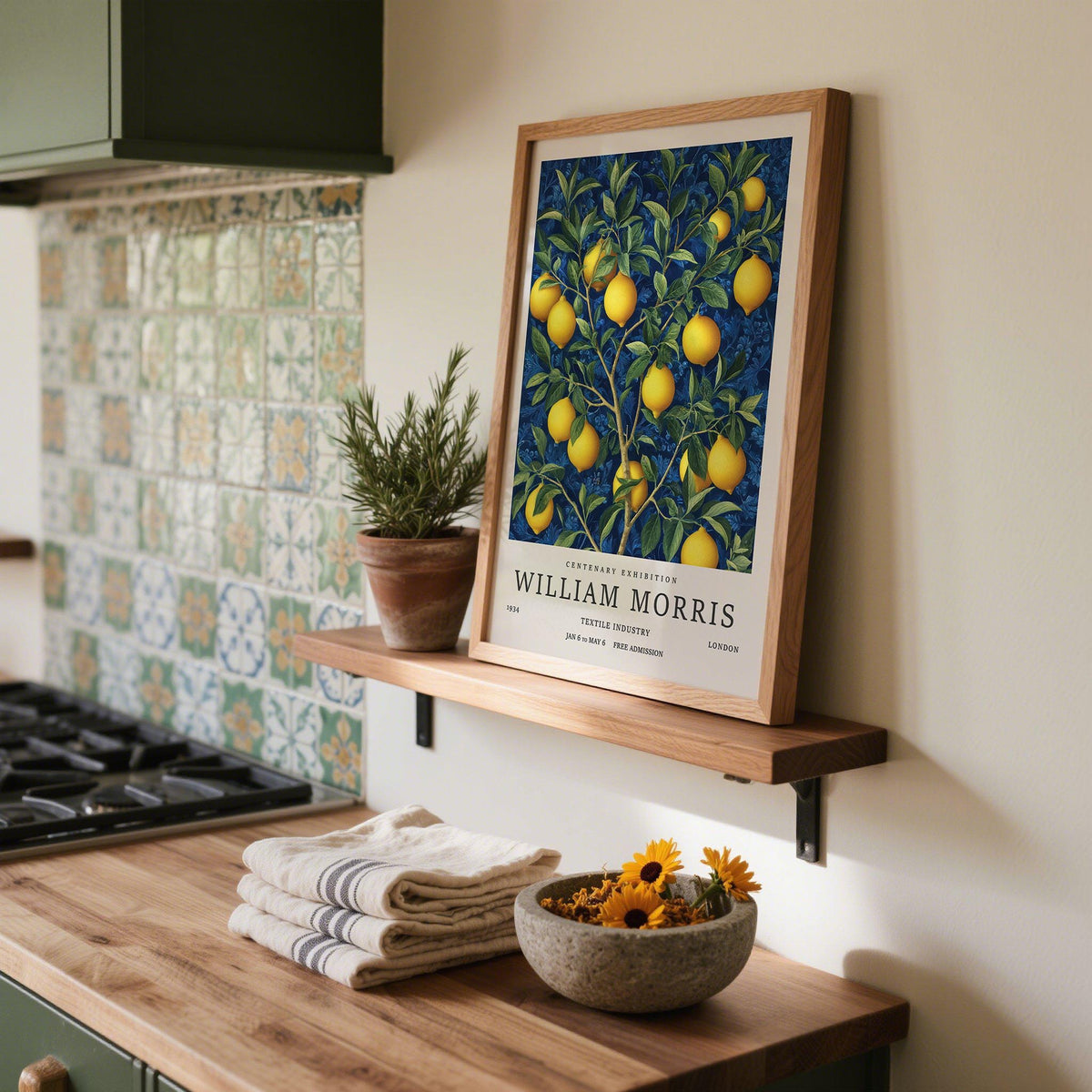 Lemon wall art with bright lemons and green leaves leaning on a kitchen shelf near a plant pot