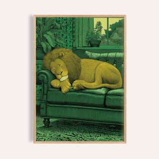 Framed Sleeping Lion Print of a yellow lion resting on a green sofa with plants in the background