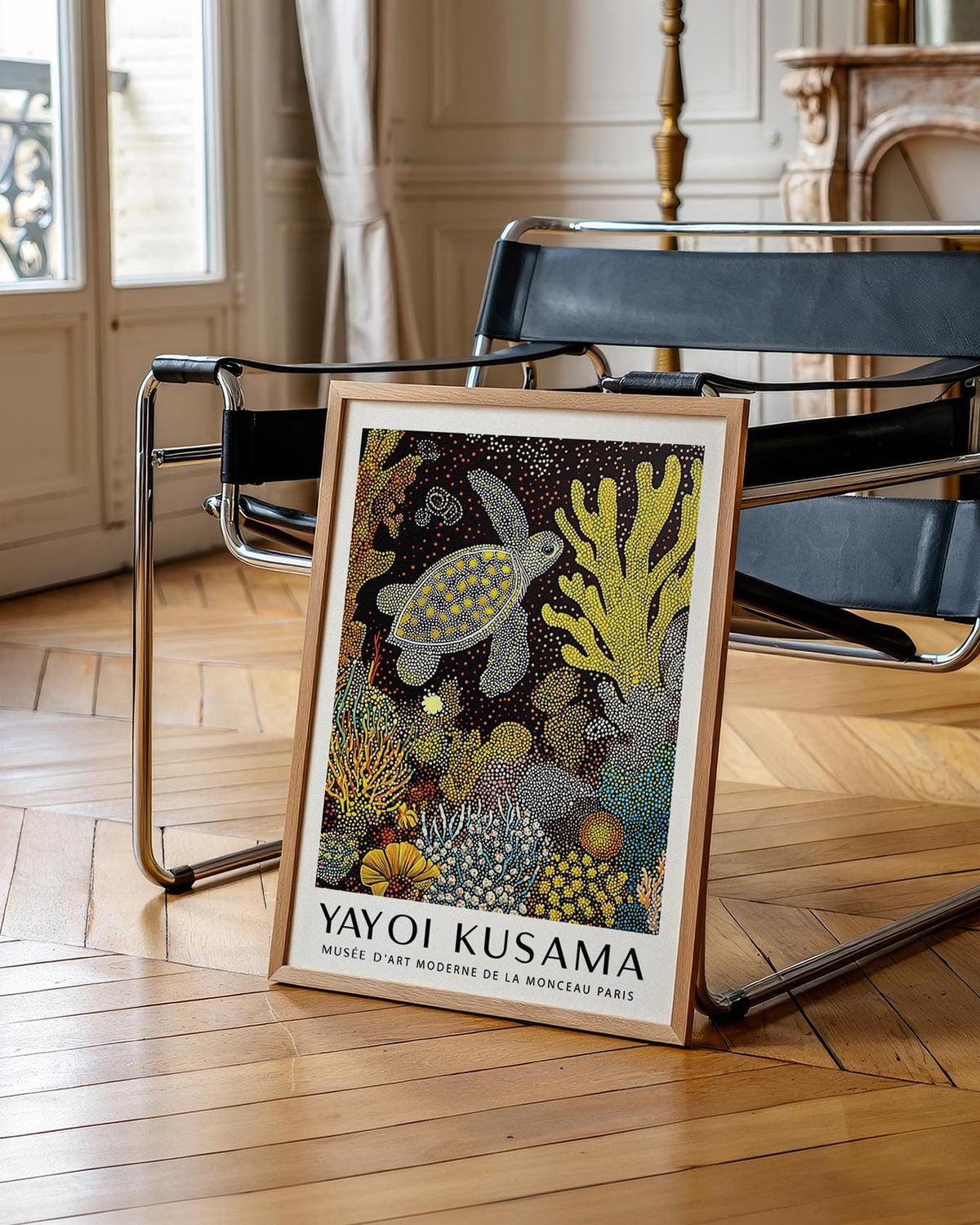 Sea turtle wall art leaning on a black modern chair with wooden frame and detailed dots