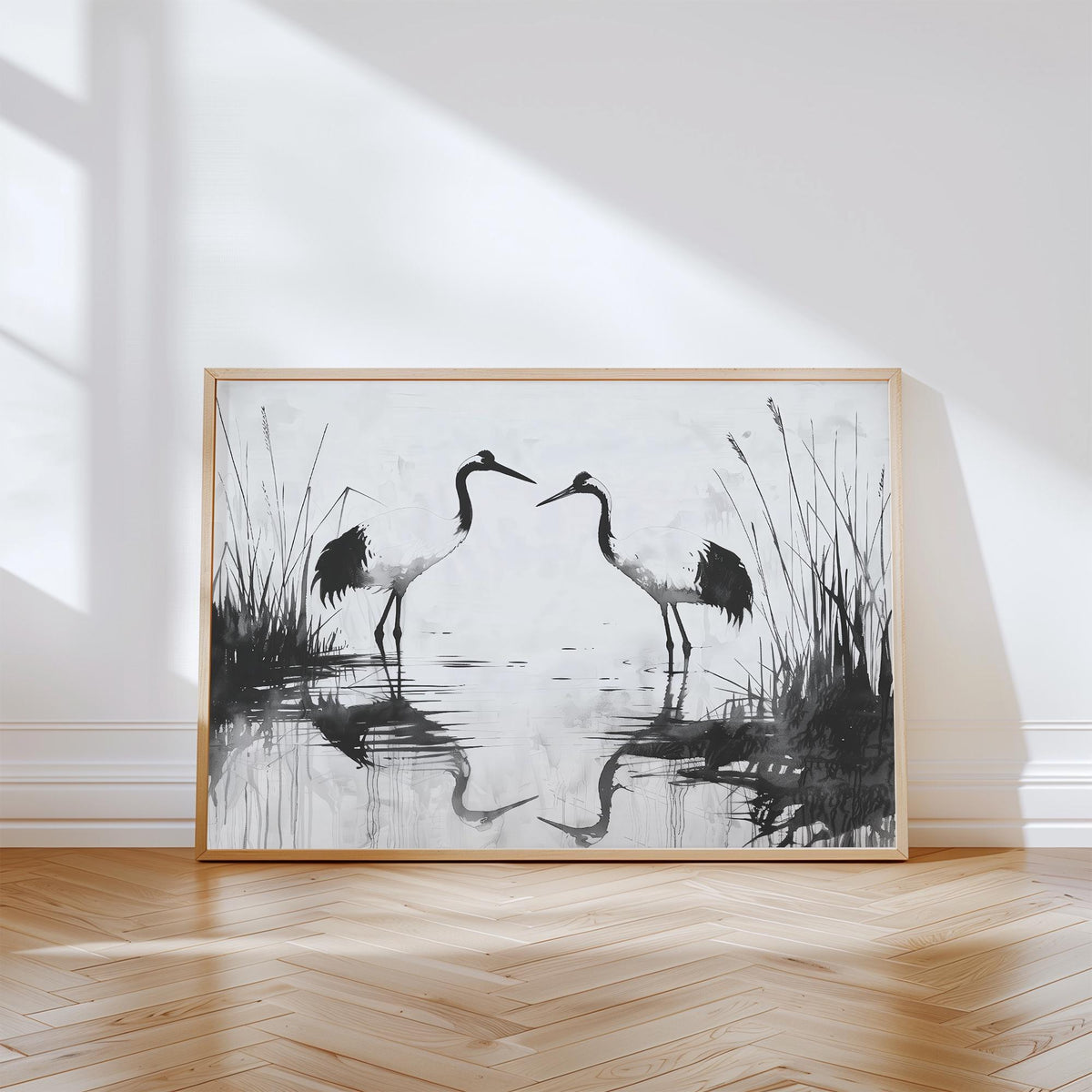 Minimalist Bird Art leaning print with pair of black and white cranes on wooden floor