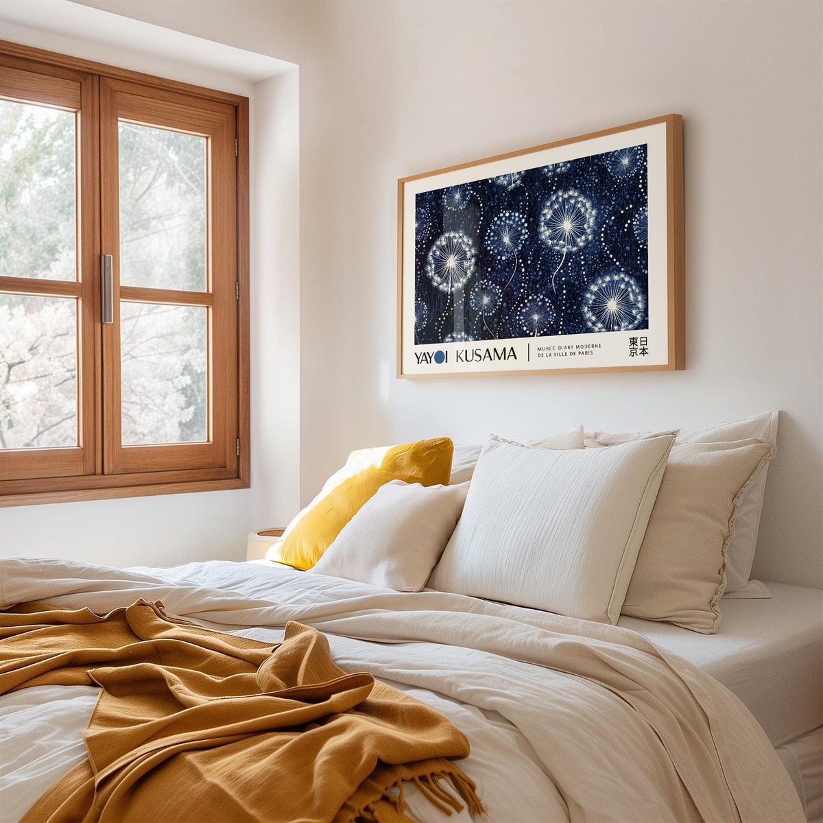 Landscape Posters with dandelion seed heads illustration in blue and white above a bed with white and mustard cushions