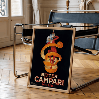 Vintage Bitter Aperitif Poster leaning on a black chair in a light wooden floor room