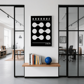 Abstract Geometric Print framed print with white shapes on black above a table with books and a blue globe