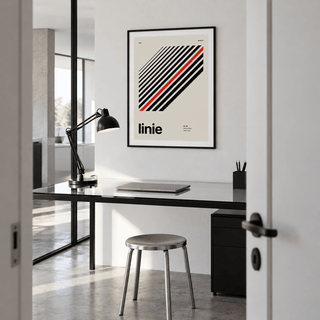 Parallel lines with one red line print in a home office against a charcoal wall