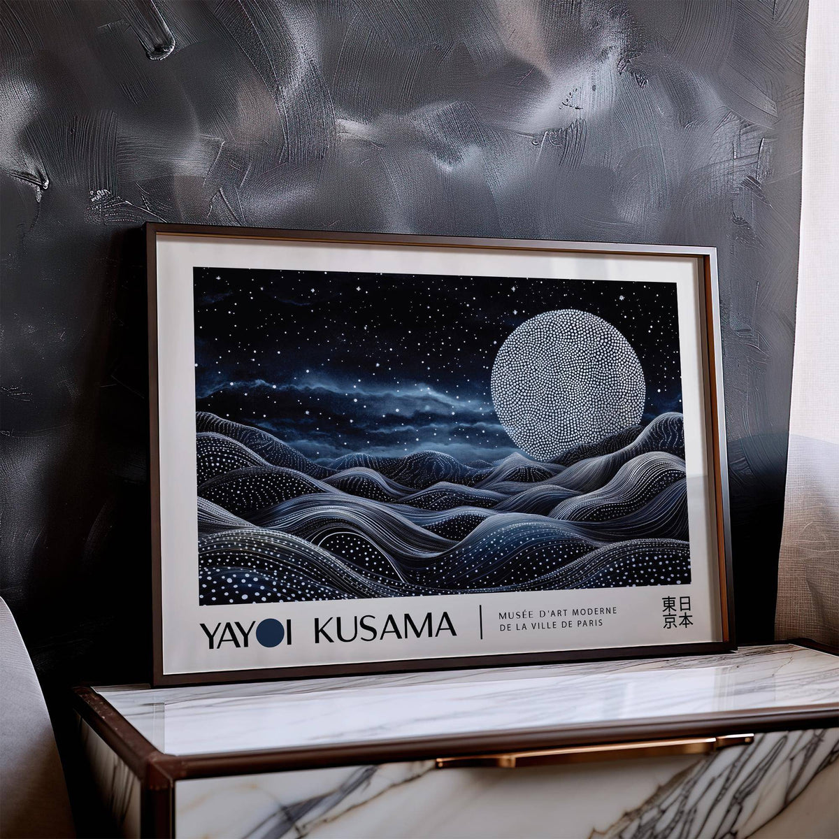 Framed Space Art Wall print of a dotted moon over wavy lines in blue and black leaning on a marble surface