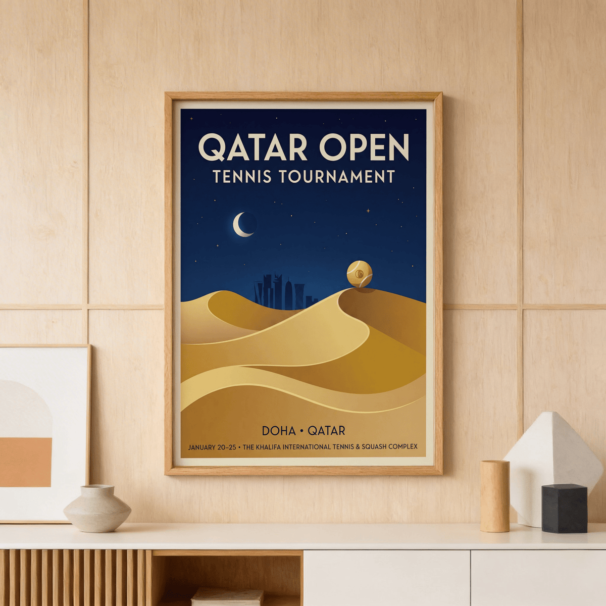 Qatar Open Tennis print of a tennis ball on a sand dune in gold on a wooden panelled wall above a sideboard with vases