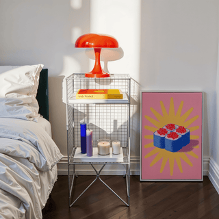 Sushi Poster print leaning on floor with a red lamp on a nearby metal shelf in a bedroom