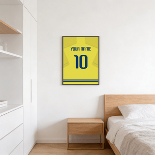 Football Shirt Poster in Yellow with Blue Number hung above a wooden bedside table in a bedroom